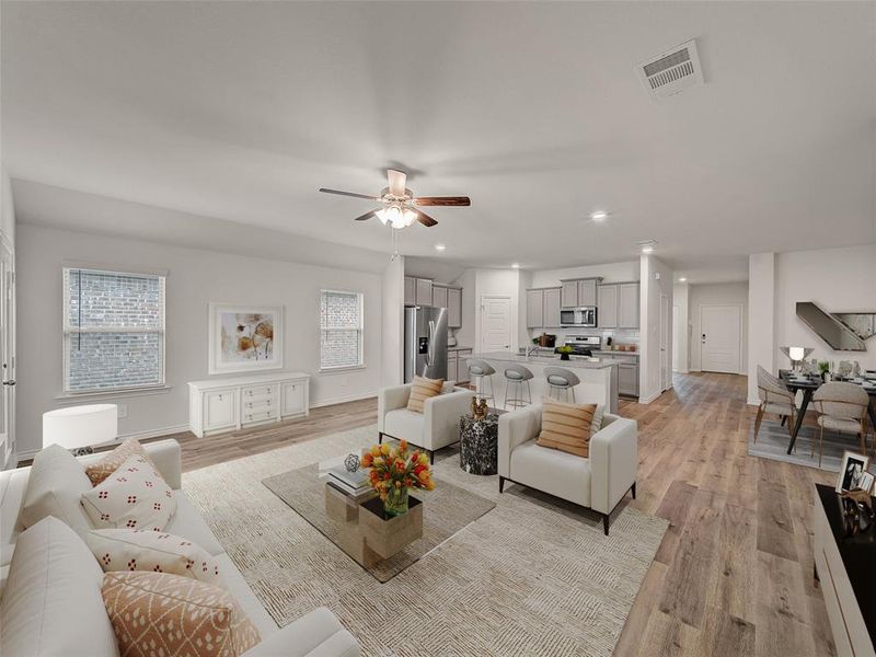 Living room with recessed lighting, light wood finished floors, baseboards, visible vents, and a ceiling fan