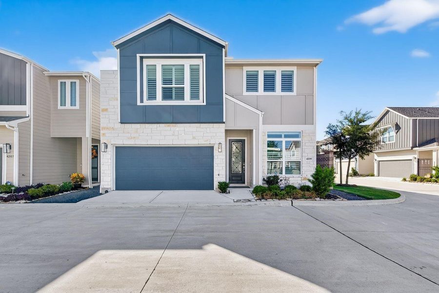 Front exterior of a new home in Spring Brook Village - Luxe Series, Houston, TX, highlighting curb appeal (Image 1).