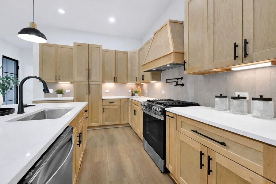 Thoughtfully designed kitchen with abundant storage and soft-close drawers.