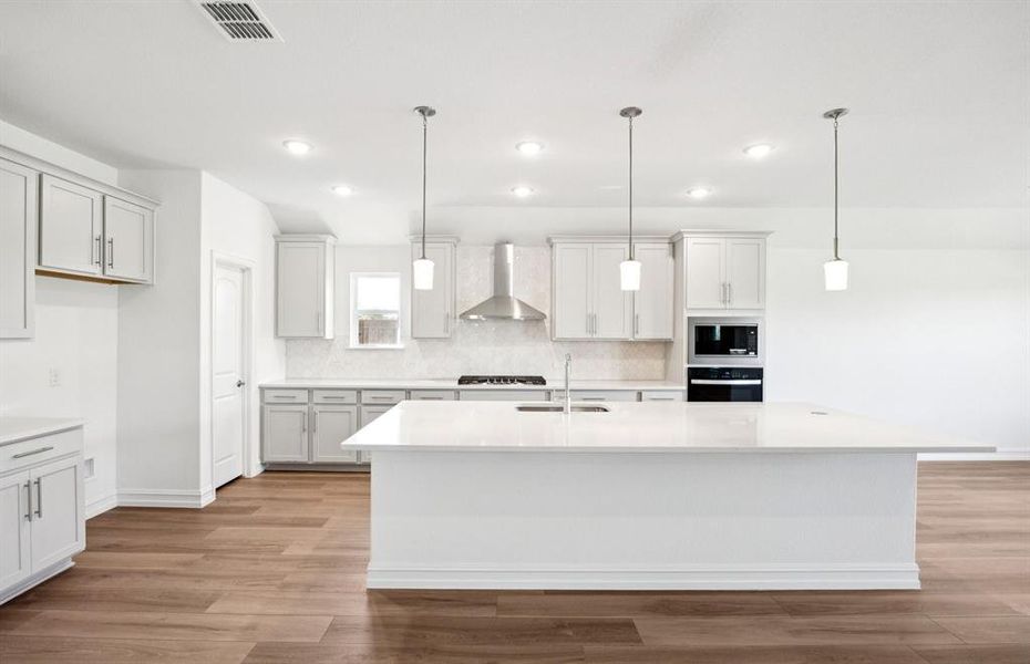 Large island overlooking gathering room and dining areas Large island overlooking gathering room and dining areas