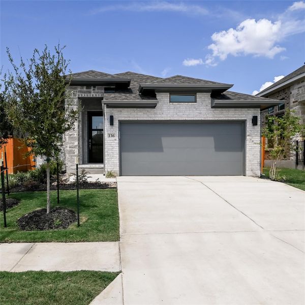 Prairie-style house with brick siding, an attached garage, roof with shingles, and driveway Prairie-style house with brick siding, an attached garage, roof with shingles, and driveway