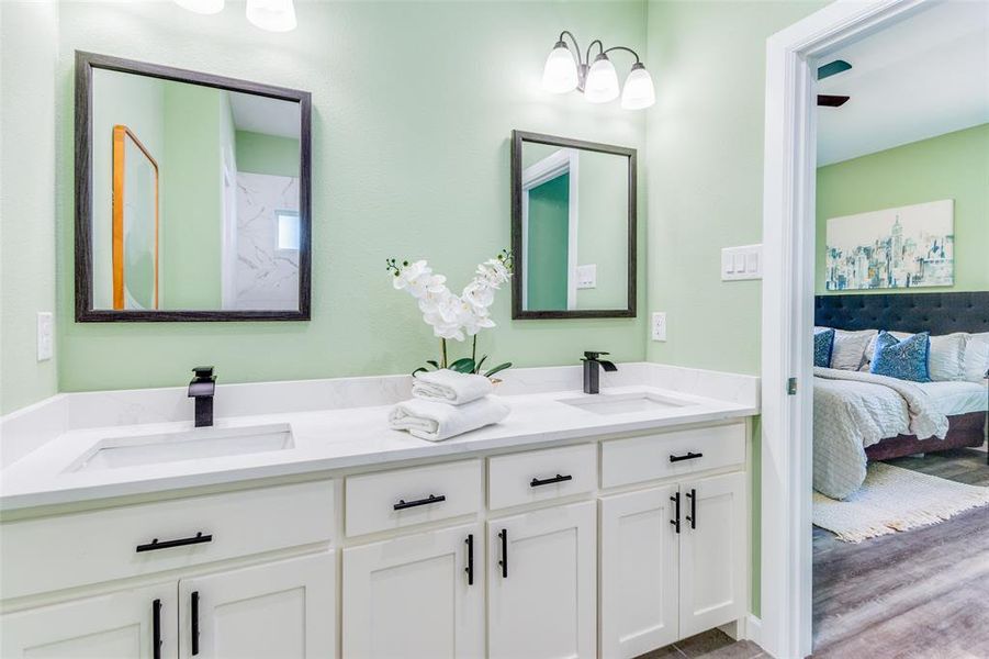 Bathroom featuring hardwood / wood-style flooring and double sink vanity