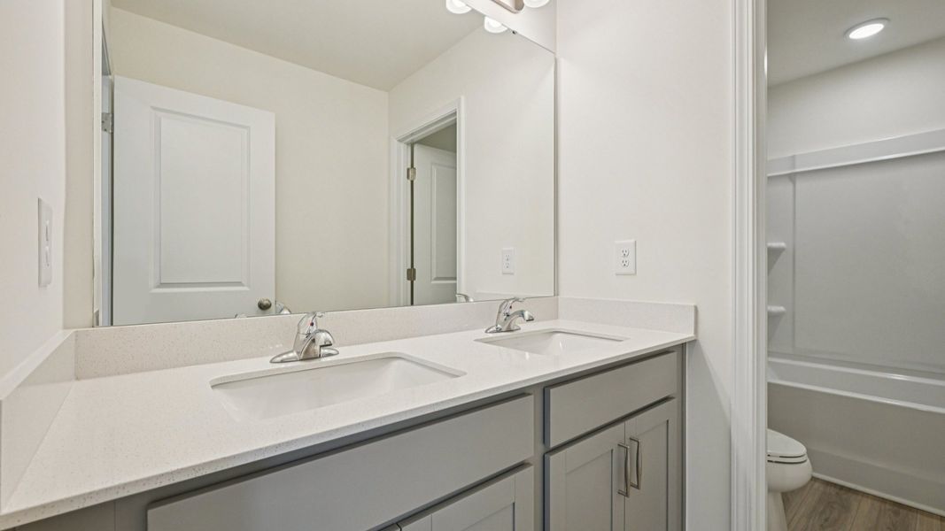 Wagener home plan secondary bathroom with dual vanities, toilet room and shower Wagener home plan secondary bathroom with dual vanities, toilet room and shower
