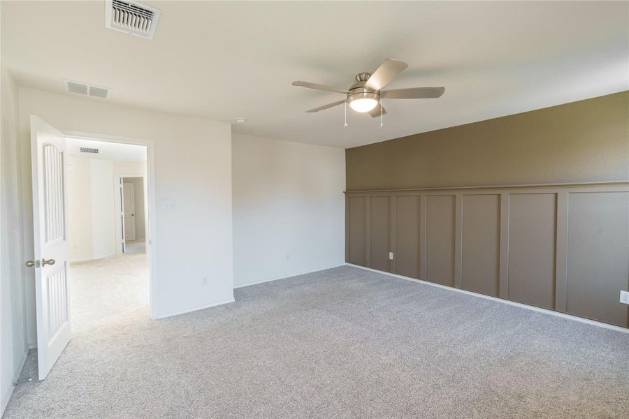 Comfortable carpet and a ceiling fan create a relaxing atmosphere in this versatile bedroom. Comfortable carpet and a ceiling fan create a relaxing atmosphere in this versatile bedroom.
