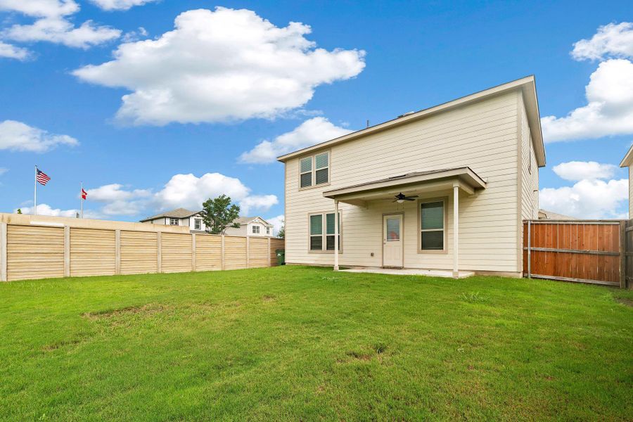 A verdant backyard retreat featuring a covered patio, perfect for outdoor relaxation and entertaining. A verdant backyard retreat featuring a covered patio, perfect for outdoor relaxation and entertaining.