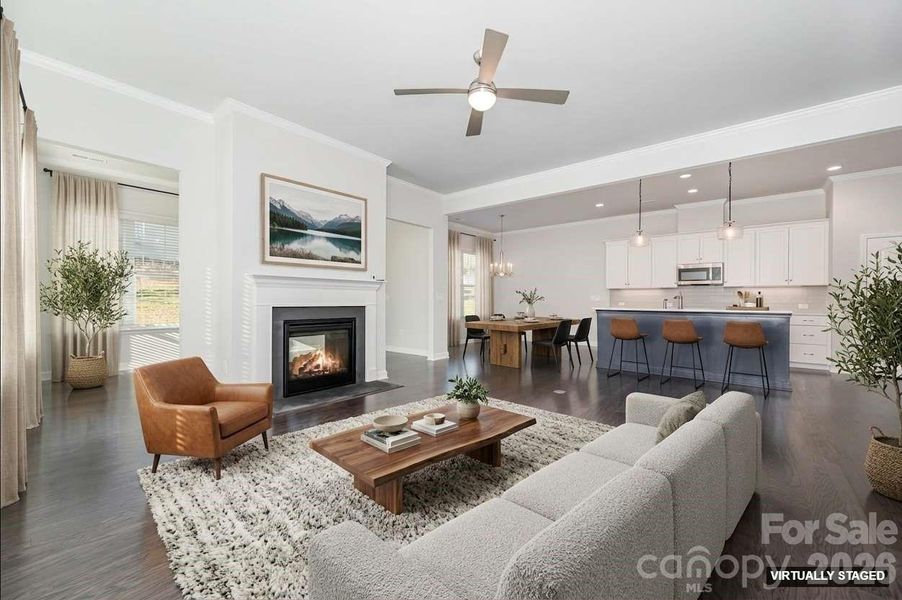 Virtually staged great room and kitchen view. Virtually staged great room and kitchen view.