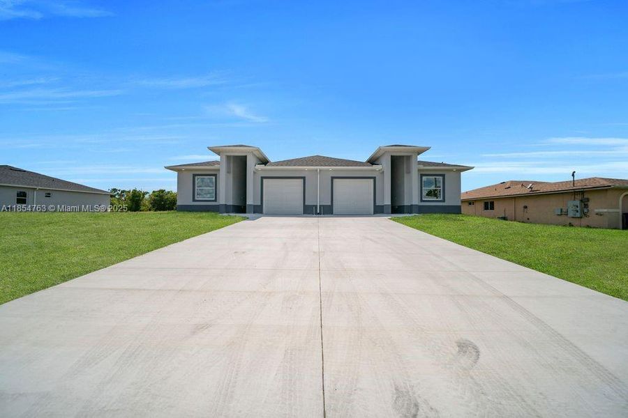 Front exterior of a new home in , Lehigh Acres, FL, highlighting curb appeal (Image 24).