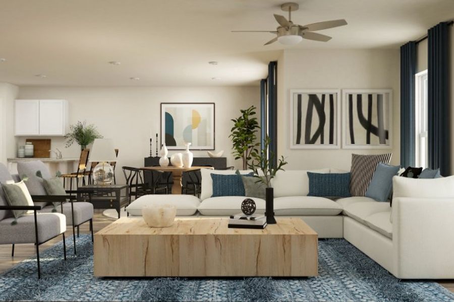 A living room with a large white couch and a table with a plant. A living room with a large white couch and a table with a plant.