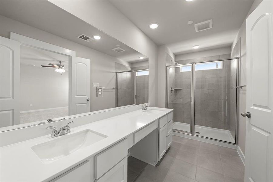 A spacious Primary Bathroom with an enormous shower.