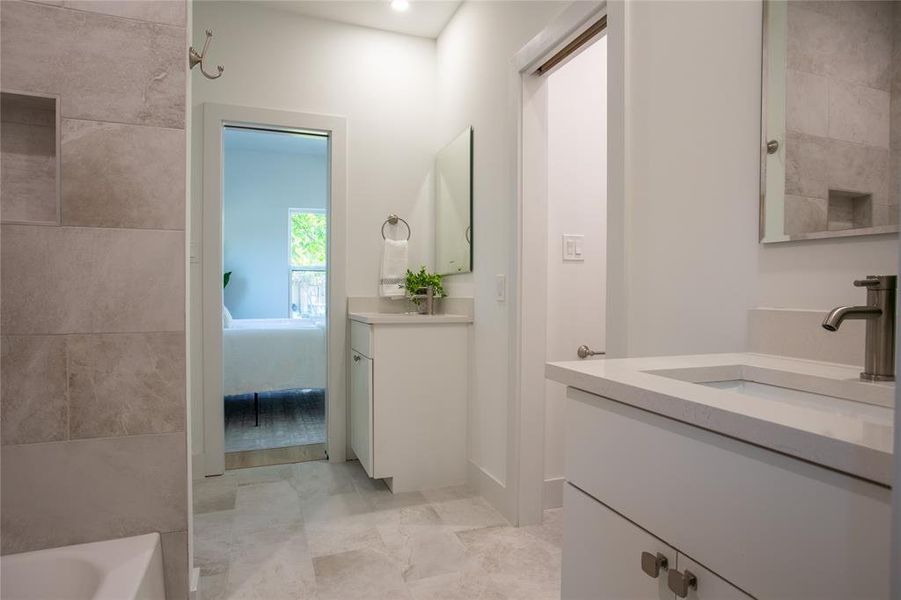 Bathroom featuring vanity and a bath