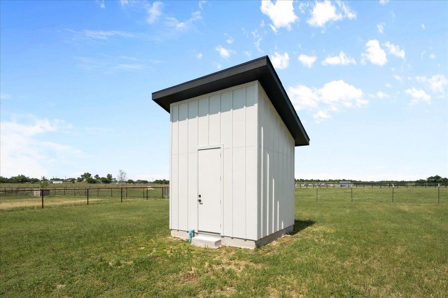 View of shed with a rural view