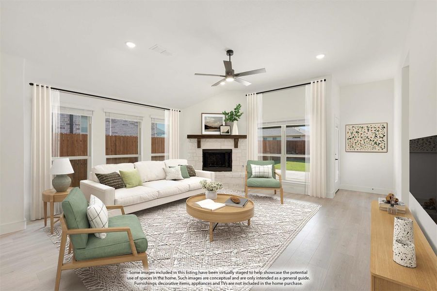 Living room with vaulted ceiling, stone fireplace, ceiling fan, and light wood floors Living room with vaulted ceiling, stone fireplace, ceiling fan, and light wood floors