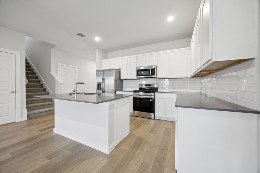 Kitchen in the Haylee home plan by Trophy Signature Homes - REPRESENTATIVE PHOTO Kitchen in the Haylee home plan by Trophy Signature Homes - REPRESENTATIVE PHOTO