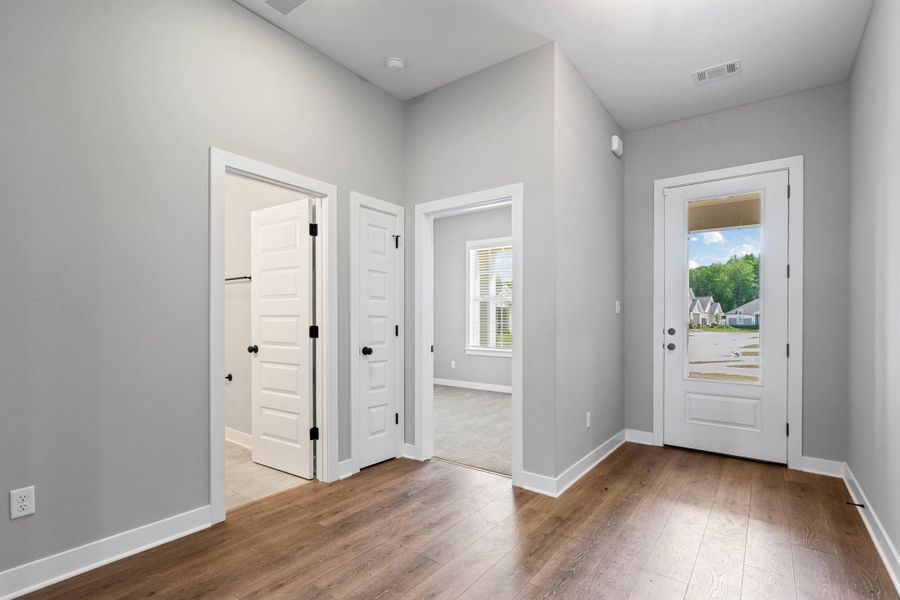 Entryway with light wood finished floors and baseboards