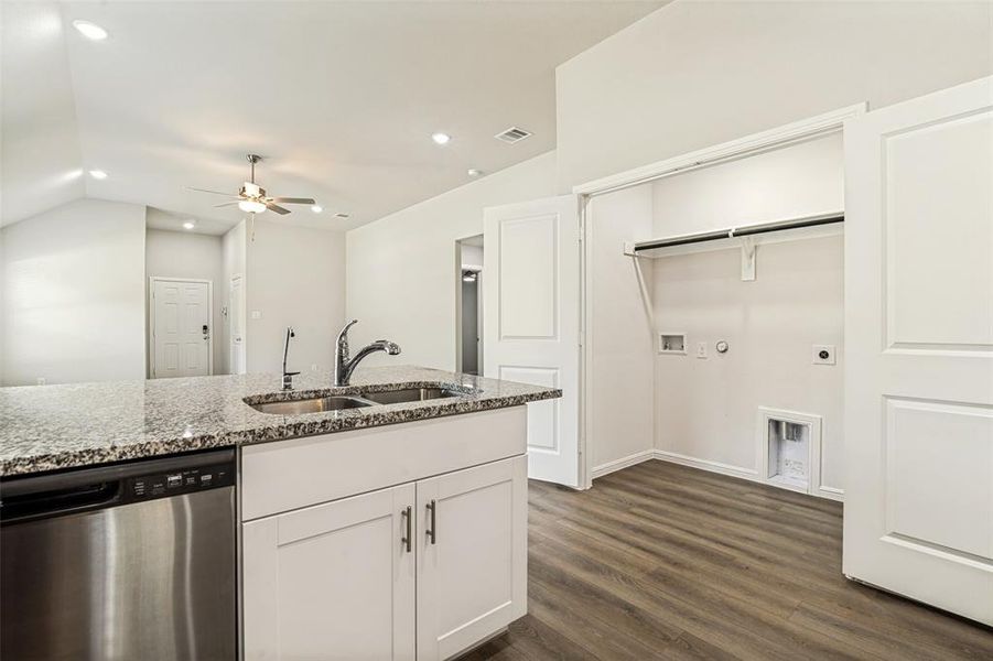Kitchen island featuring a double basin sink and stainless steel dishwasher Kitchen island featuring a double basin sink and stainless steel dishwasher