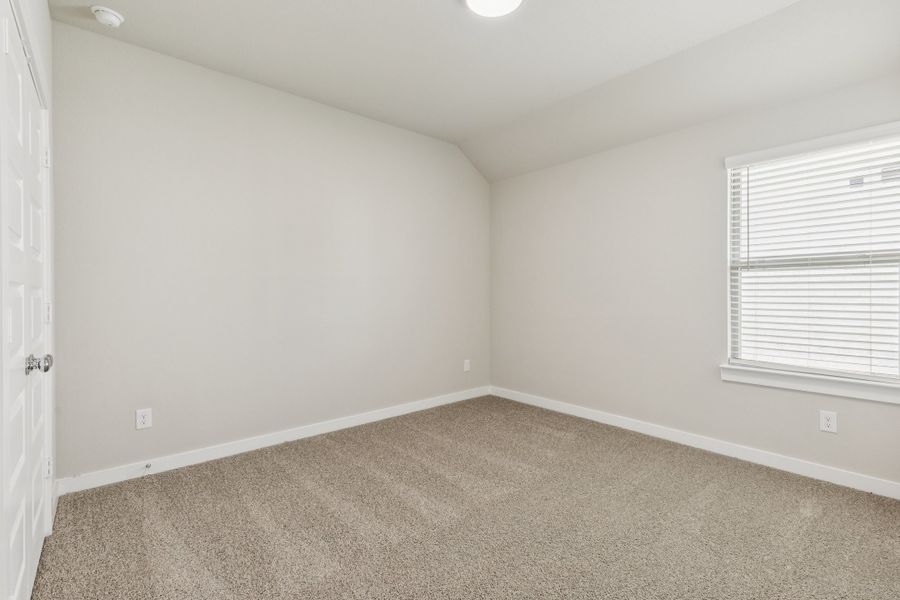 Bedroom in the Heisman home plan by Trophy Signature Homes – REPRESENTATIVE PHOTO Bedroom in the Heisman home plan by Trophy Signature Homes – REPRESENTATIVE PHOTO