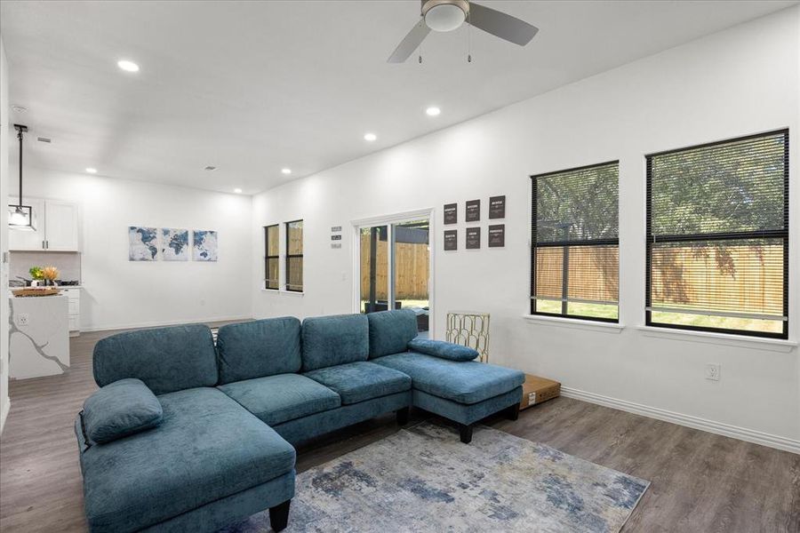 Living room with hardwood / wood-style floors and ceiling fan