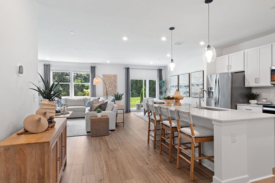 A kitchen with a dining table and couches.
