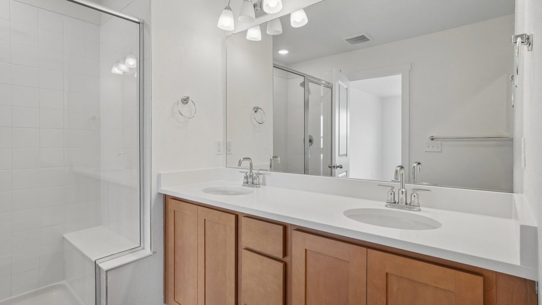 Primary bathroom with dual vanity and quality finishes. Primary bathroom with dual vanity and quality finishes.