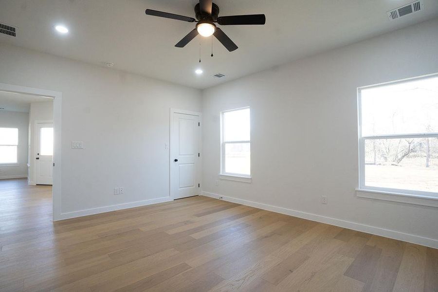 Spare room featuring ceiling fan, light wood-style flooring, and recessed lighting