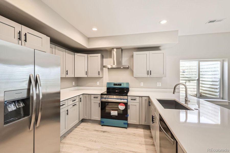 Check out this awesome kitchen! It provides shaker style cabinetry, soft-close Euro style doors/drawers, quartz countertop, stainless steel appliances and a peninsula with lots of seating.