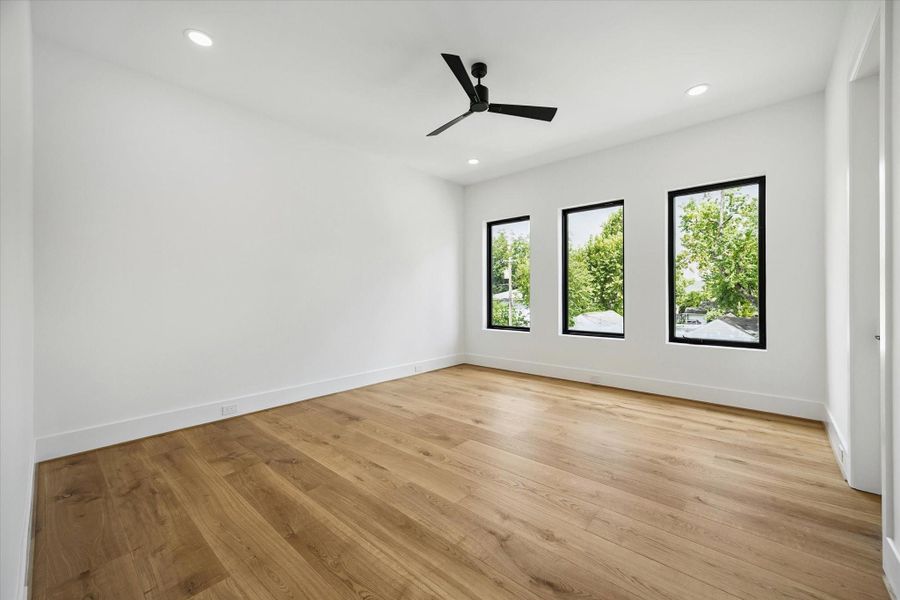 Secondary bedroom with hardwood floors and large windows. Secondary bedroom with hardwood floors and large windows.
