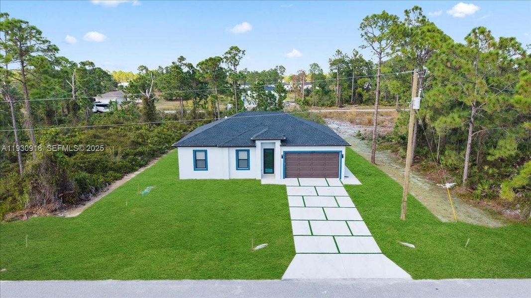 Front exterior of a new home in , Lehigh Acres, FL, highlighting curb appeal (Image 26). Front exterior of a new home in , Lehigh Acres, FL, highlighting curb appeal (Image 26).