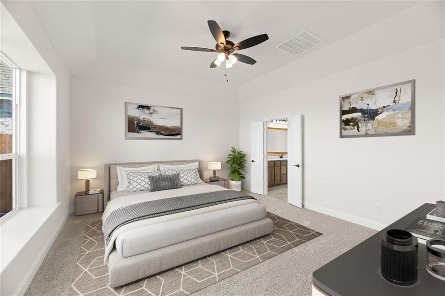 Carpeted bedroom featuring ceiling fan, a tray ceiling, and ensuite bathroom Carpeted bedroom featuring ceiling fan, a tray ceiling, and ensuite bathroom