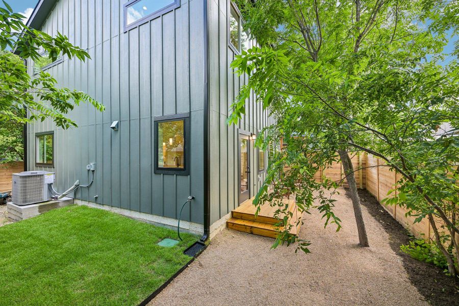 A private backyard oasis with mature trees, grass, and a fenced-in yard for tranquil outdoor living. A private backyard oasis with mature trees, grass, and a fenced-in yard for tranquil outdoor living.