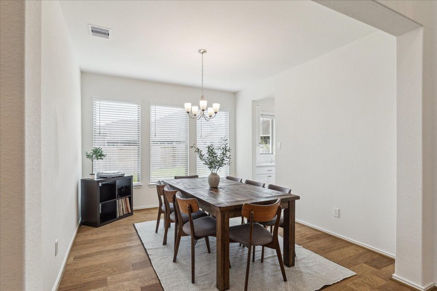 The dedicated dining room exudes warmth and charm, with ample space to seat eight. Three large windows overlook the yard, filling the room with natural light. Conveniently located off the entry, the space also connects seamlessly to the butler’s pantry for effortless entertaining.