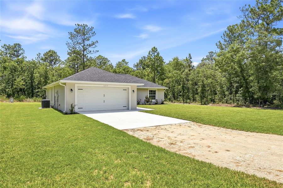 Front exterior of a new home in , Weeki Wachee, FL, highlighting curb appeal (Image 26). Front exterior of a new home in , Weeki Wachee, FL, highlighting curb appeal (Image 26).