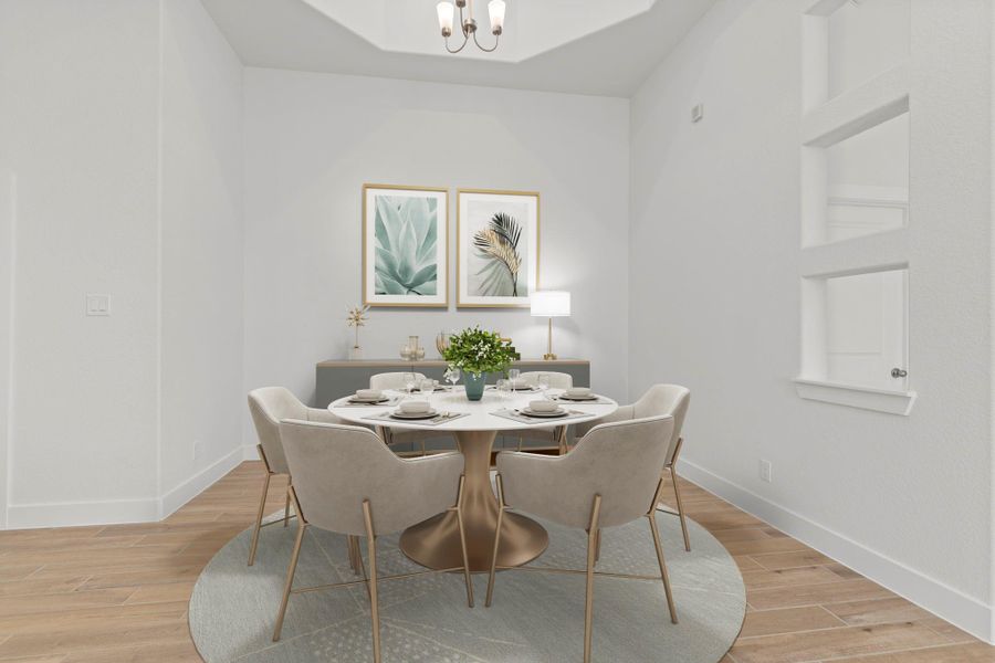The dramatic dining area with high coffered ceilings and opens and flows into the gourmet kitchen and the stunning large family area. *Virtually Staged*