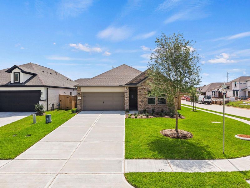Front exterior of a new home in Windrose Green, Angleton, TX, highlighting curb appeal (Image 19). Front exterior of a new home in Windrose Green, Angleton, TX, highlighting curb appeal (Image 19).