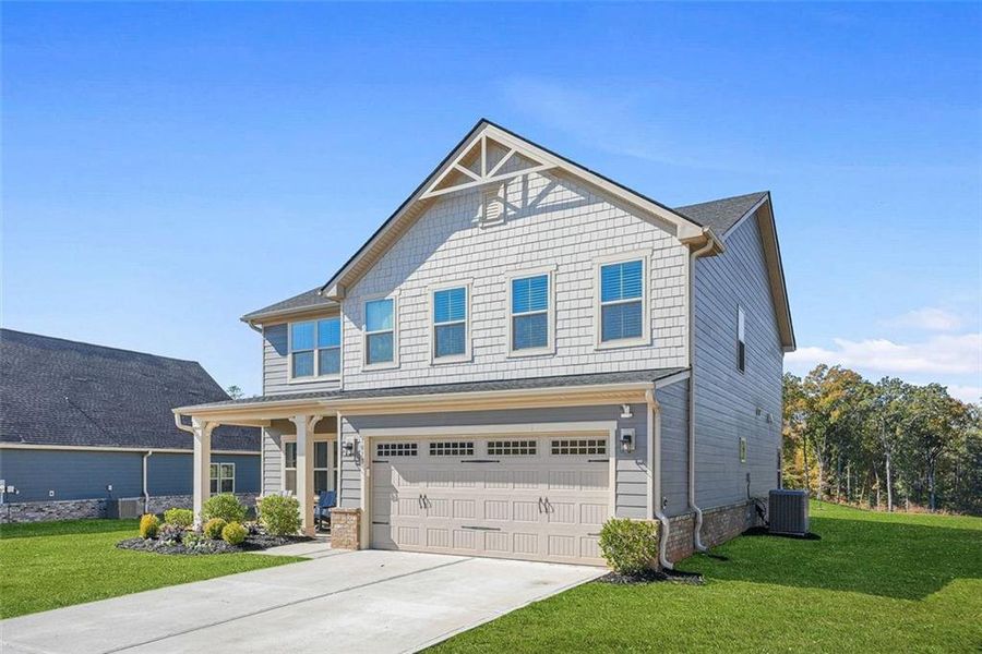 Front exterior of a new home in Southern Hills, McDonough, GA, highlighting curb appeal (Image 1).