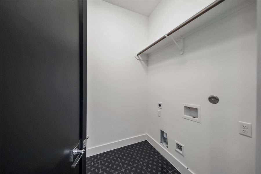 Stylish patterned tile flooring elevates this functional laundry area. Stylish patterned tile flooring elevates this functional laundry area.