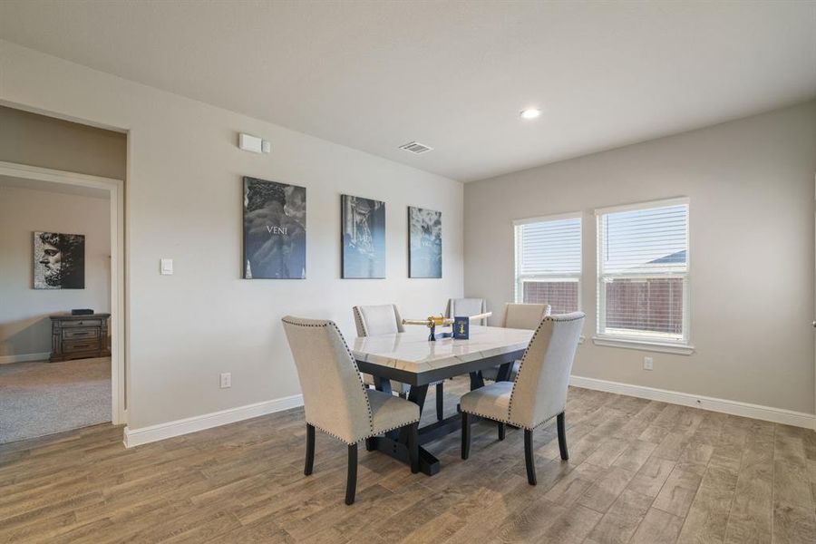 Dining space with light wood-type flooring and recessed lighting Dining space with light wood-type flooring and recessed lighting