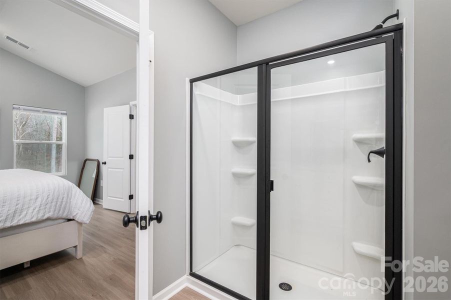 Primary Walk-in Shower with doors and black modern framing