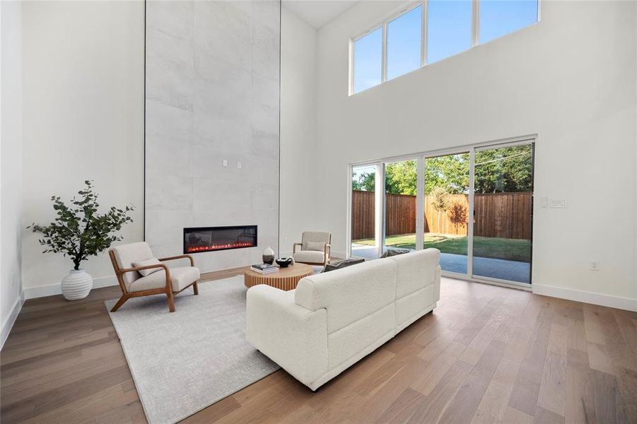 Living room featuring a tile fireplace and wood-type flooring