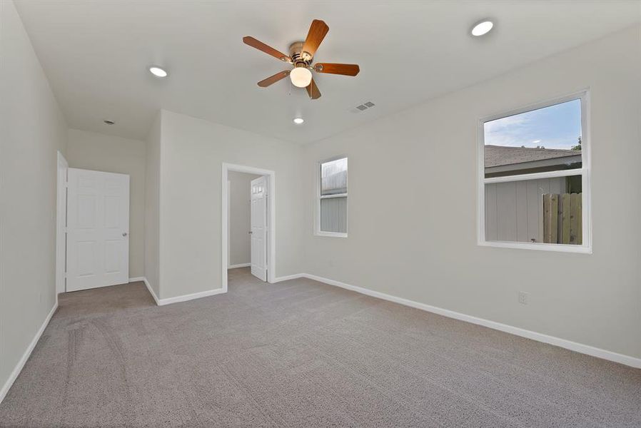 Unfurnished bedroom featuring carpet floors, recessed lighting, and a ceiling fan