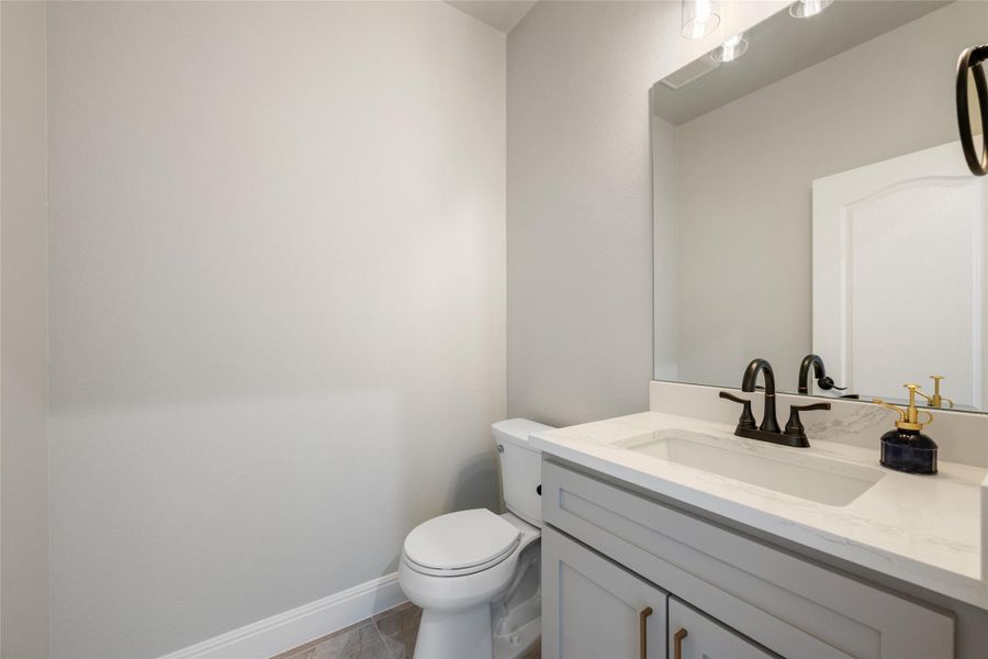 Bathroom with vanity and baseboards
