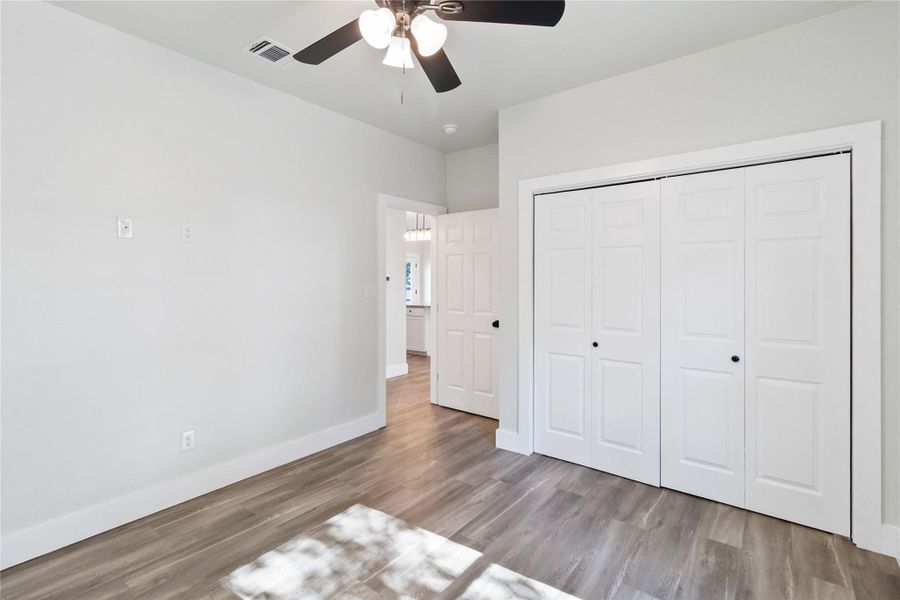 Unfurnished bedroom featuring light wood-type flooring, a closet, and ceiling fan