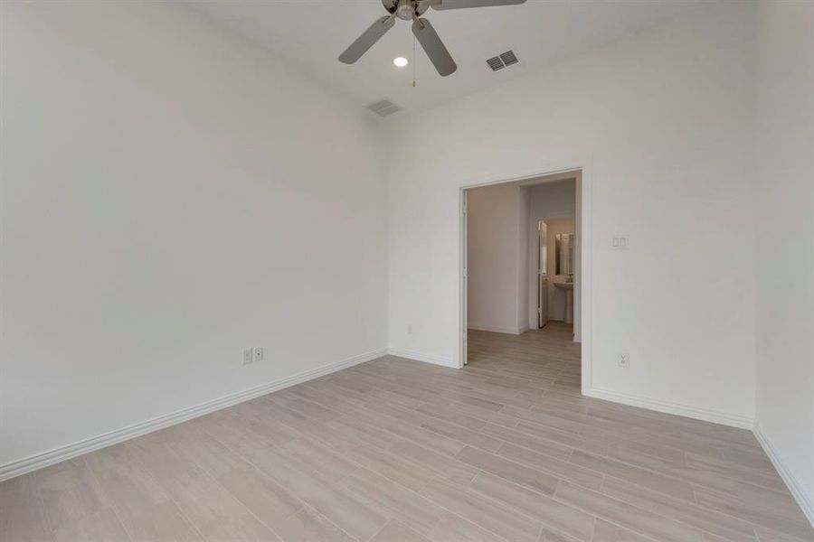 Empty room featuring ceiling fan and light wood-type flooring