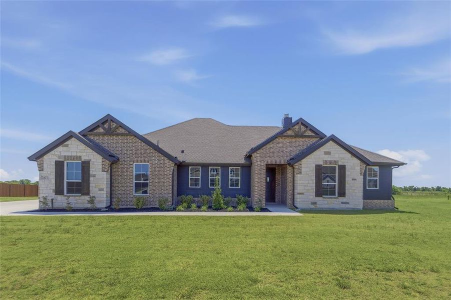 Spacious one-story residence featuring a combination of brick and stone masonry, dark siding, and a dark shingled roof Spacious one-story residence featuring a combination of brick and stone masonry, dark siding, and a dark shingled roof