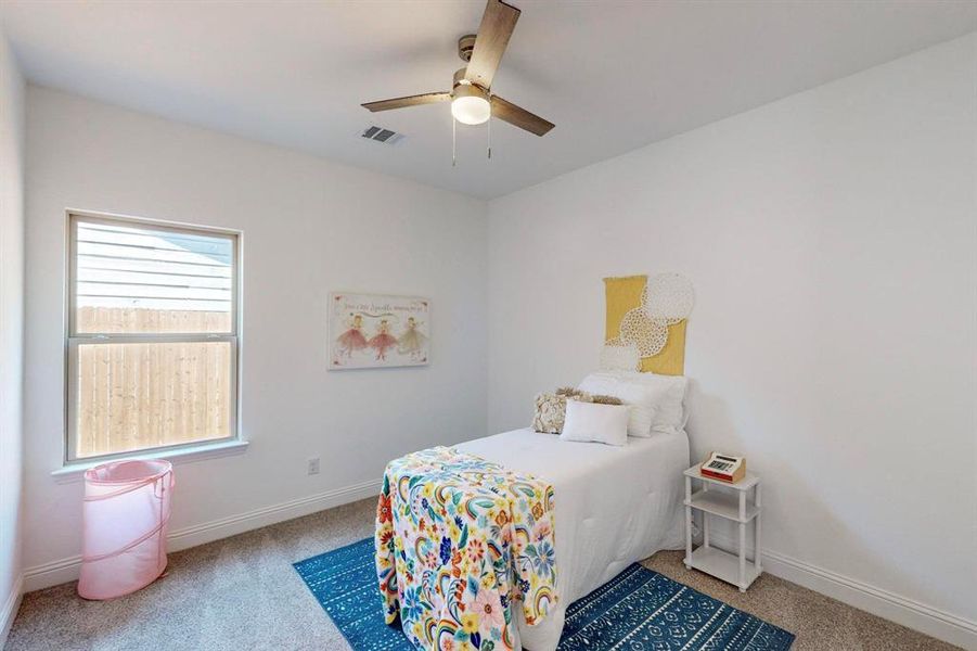 Carpeted bedroom with ceiling fan