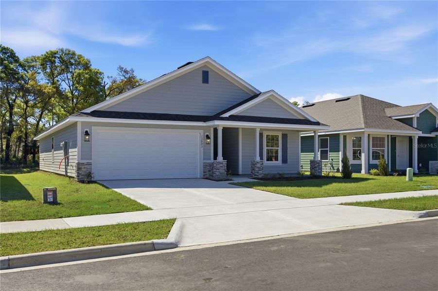 Front exterior of a new home in Briarwood, Alachua, FL, highlighting curb appeal (Image 15).