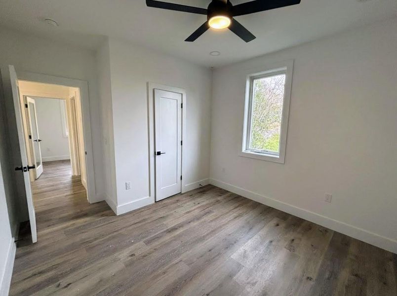 Unfurnished bedroom with light wood-type flooring and ceiling fan