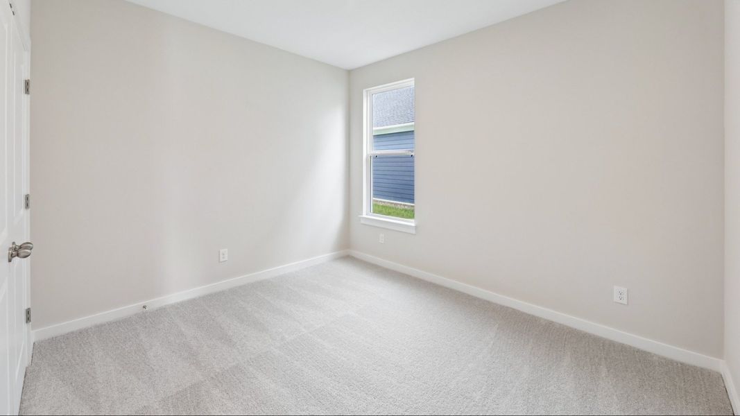Secondary Bedroom with carpet and window