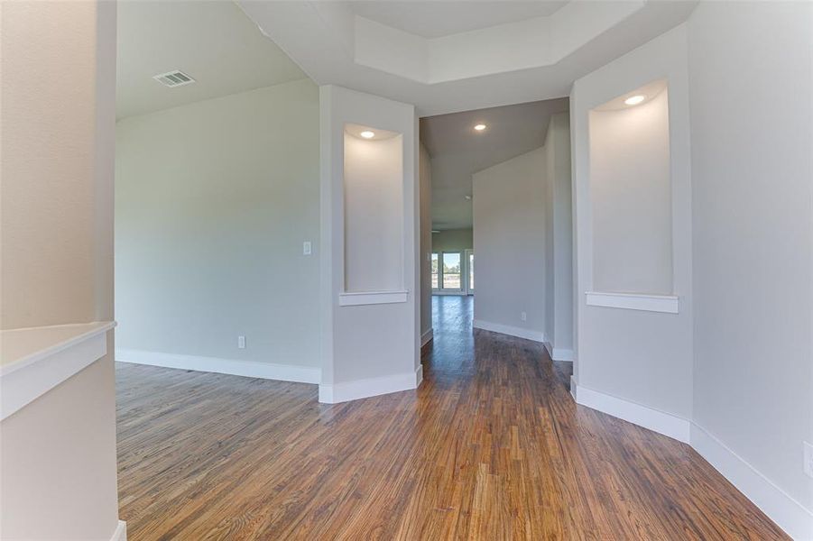 Unfurnished room with dark wood-type flooring