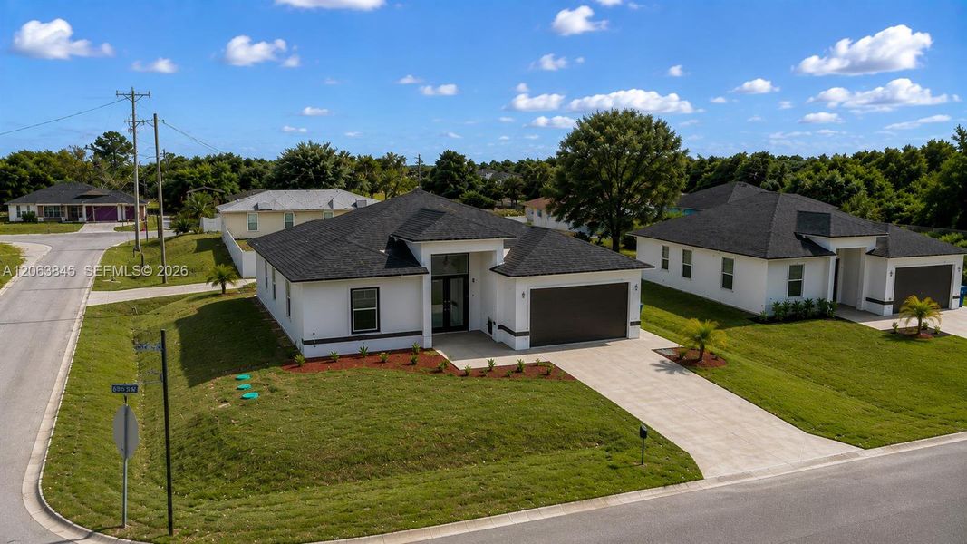 Front exterior of a new home in , Lehigh Acres, FL, highlighting curb appeal (Image 24).