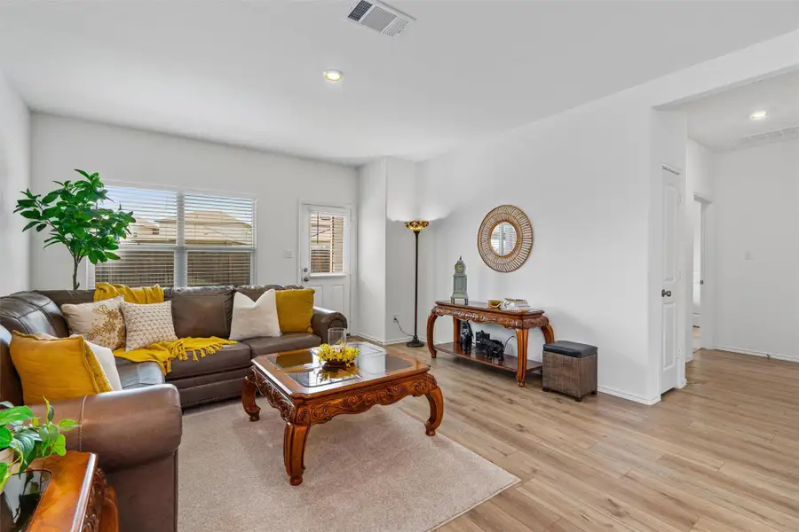 Living area with recessed lighting and light wood-style flooring